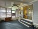 Enclosed patio features sliding doors, blue carpet, ceiling fan and extra storage at 22 Nautical Dr, North Port, FL 34287
