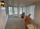 Enclosed sunroom with carpet, bright light fixtures, windows, and wicker furniture at 22 Nautical Dr, North Port, FL 34287