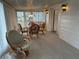 Enclosed sunroom with carpet, bright light fixtures, windows, and a table with chairs at 22 Nautical Dr, North Port, FL 34287
