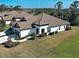 Aerial view of a home with a tile roof, manicured lawn, and a paver walkway leading to the entrance at 220 Sarezzo Cir, Nokomis, FL 34275