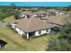 Aerial view of a home with a backyard, screened-in lanai, and a tile roof at 220 Sarezzo Cir, Nokomis, FL 34275