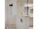 Close-up of modern walk-in shower with rainfall showerhead and mosaic tile floor at 220 Sarezzo Cir, Nokomis, FL 34275