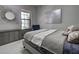 Comfortable bedroom with a bed, stylish wall decor, and natural light at 220 Sarezzo Cir, Nokomis, FL 34275