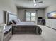 Spacious bedroom with a comfortable bed, dedicated workspace, and plenty of storage at 220 Sarezzo Cir, Nokomis, FL 34275