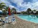 Inviting community pool surrounded by brick and comfortable seating areas at 220 Sarezzo Cir, Nokomis, FL 34275