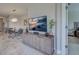Open concept dining room and living area with an entertainment center at 220 Sarezzo Cir, Nokomis, FL 34275