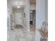 Inviting entryway with white shelving, a neutral rug, and a view into the adjacent bedroom at 220 Sarezzo Cir, Nokomis, FL 34275
