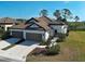 Beautiful single-story home boasts a well manicured lawn, two-car garage and a clay tile roof at 220 Sarezzo Cir, Nokomis, FL 34275