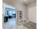 Entryway with views to an office with large windows and desk, and a white door at 220 Sarezzo Cir, Nokomis, FL 34275