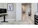 Elegant hallway featuring marble floors, leading to a bathroom and walk-in closet, showcasing modern interior design at 220 Sarezzo Cir, Nokomis, FL 34275