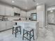 Kitchen island with seating, modern appliances, and white cabinetry for a bright, open space at 220 Sarezzo Cir, Nokomis, FL 34275