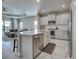 Bright kitchen featuring a central island, stainless steel appliances and white cabinets at 220 Sarezzo Cir, Nokomis, FL 34275