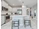 Bright kitchen featuring white cabinetry, stainless steel appliances and counter seating at 220 Sarezzo Cir, Nokomis, FL 34275