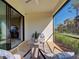 Screened lanai with cozy seating, providing a relaxing outdoor space at 220 Sarezzo Cir, Nokomis, FL 34275