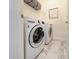 Laundry room featuring modern appliances and tile flooring at 220 Sarezzo Cir, Nokomis, FL 34275