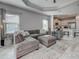 Open concept living room featuring contemporary furniture and a view into the kitchen at 220 Sarezzo Cir, Nokomis, FL 34275