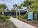 Vicenza's pickleball courts surrounded by lush landscaping, with rules and court activity at 220 Sarezzo Cir, Nokomis, FL 34275