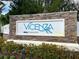 A sign for Vicenza Neal Communities is displayed in front of small bushes at 220 Sarezzo Cir, Nokomis, FL 34275