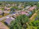 Aerial view of homes in a residential neighborhood with mature trees at 2318 Harrier Way, Nokomis, FL 34275