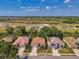 Aerial view of the home with a manicured lawn and spacious driveway at 2318 Harrier Way, Nokomis, FL 34275