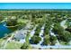 Aerial view of the community clubhouse, golf course, parking lot and surrounding landscape at 2318 Harrier Way, Nokomis, FL 34275