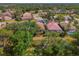 Aerial view of a home surrounded by trees and a small canal at 2318 Harrier Way, Nokomis, FL 34275