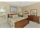 Cozy bedroom featuring a wooden bed frame, soft lighting, and a serene atmosphere at 2318 Harrier Way, Nokomis, FL 34275