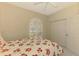 Bright bedroom featuring a white ceiling fan and a window with plantation shutters at 2318 Harrier Way, Nokomis, FL 34275