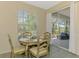 Cozy dining area with natural light and sliding door access to the outdoor patio at 2318 Harrier Way, Nokomis, FL 34275