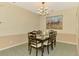 Dining area features a charming chandelier and an adjacent pass through to kitchen at 2318 Harrier Way, Nokomis, FL 34275