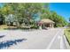 Community entrance with a small guardhouse and mature trees at 2318 Harrier Way, Nokomis, FL 34275