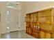 Inviting foyer with a striking wooden cabinet and tiled floors at 2318 Harrier Way, Nokomis, FL 34275