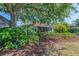 Charming home exterior with screened lanai and lush landscaping at 2318 Harrier Way, Nokomis, FL 34275