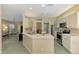 Bright kitchen features stainless steel appliances, ample counter space, and a view into the adjacent living room at 2318 Harrier Way, Nokomis, FL 34275