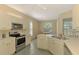 Bright kitchen with stainless steel appliances and a view of the dining area and natural light at 2318 Harrier Way, Nokomis, FL 34275
