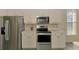 Well-equipped kitchen with stainless steel appliances, providing modern functionality for daily cooking at 2318 Harrier Way, Nokomis, FL 34275
