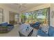 Screened lanai features comfortable seating and views of the green landscaped yard at 2318 Harrier Way, Nokomis, FL 34275