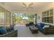 Relaxing screened lanai with comfortable patio furniture overlooking serene backyard views at 2318 Harrier Way, Nokomis, FL 34275