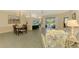 Open-concept living room and dining area offer seamless flow and access to the lanai at 2318 Harrier Way, Nokomis, FL 34275