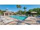 Community pool with ample seating, a shaded pavilion, and well-maintained surroundings at 2318 Harrier Way, Nokomis, FL 34275