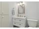 Clean bathroom featuring a modern vanity, mirror, and efficient storage solutions at 244 Saint Augustine # 605, Venice, FL 34285