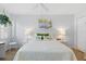 Inviting bedroom with a plush bed, ceiling fan, and cheerful tropical-themed decor at 244 Saint Augustine # 605, Venice, FL 34285