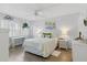 Bright bedroom with a comfortable bed, shutters, ceiling fan, and stylish decor at 244 Saint Augustine # 605, Venice, FL 34285