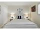 Bedroom featuring a seahorse throw pillow, side tables, and light walls at 244 Saint Augustine # 605, Venice, FL 34285