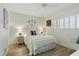 Cozy bedroom featuring a seahorse throw pillow, shutters and wood-look flooring at 244 Saint Augustine # 605, Venice, FL 34285