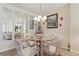 Charming dining area with glass table, wicker chairs, and decorative wall art at 244 Saint Augustine # 605, Venice, FL 34285