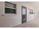 Exterior hallway featuring a storm door and windows providing natural light at 244 Saint Augustine # 605, Venice, FL 34285
