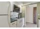 Compact kitchen with white appliances, updated cabinets, and sleek hardware at 244 Saint Augustine # 605, Venice, FL 34285
