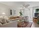 Inviting living room with comfortable seating, ceiling fan, and access to a private balcony at 244 Saint Augustine # 605, Venice, FL 34285