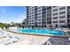 Community pool with lounge chairs and a multi-story building in the background at 244 Saint Augustine # 605, Venice, FL 34285